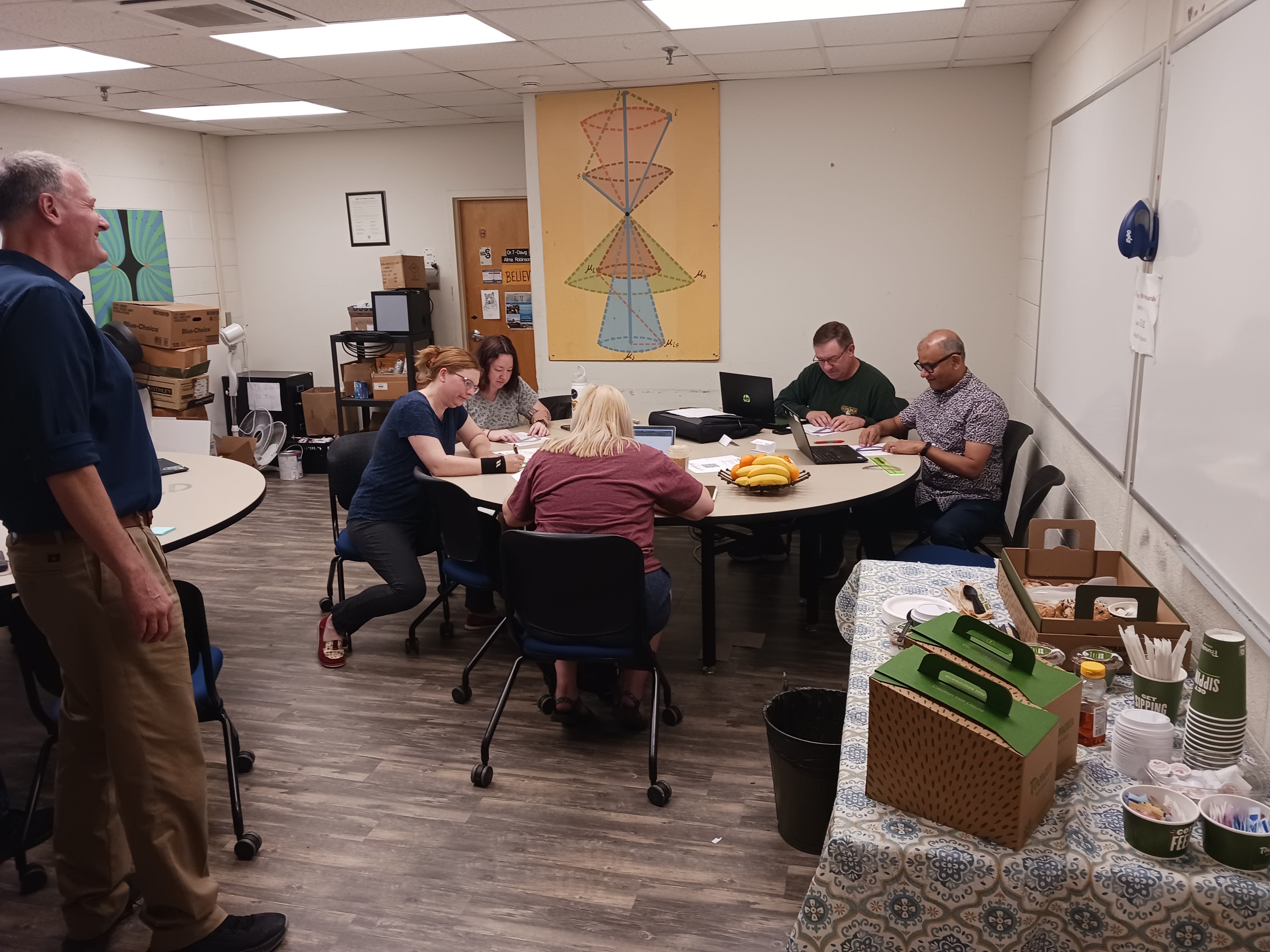 Joel looks on benevolently as the VT teachers work on understanding relativity.